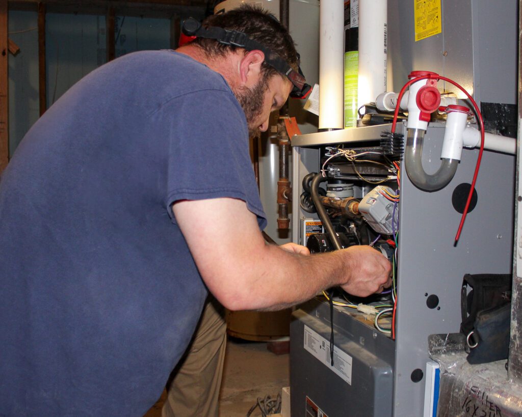 MDi HVAC technician performing residential HVAC maintenance on a furnace as part of a complete HVAC and plumbing maintenance plan MDi HVAC technician performing residential HVAC maintenance on a furnace as part of a complete HVAC and plumbing maintenance plan MDi HVAC technician performing residential HVAC maintenance on a furnace as part of a complete HVAC and plumbing maintenance plan