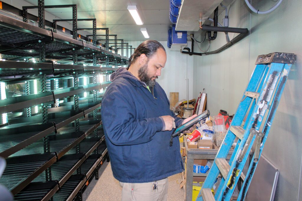 Certified technician performing commercial HVAC and plumbing inspection in office building to ensure code compliance and system safety