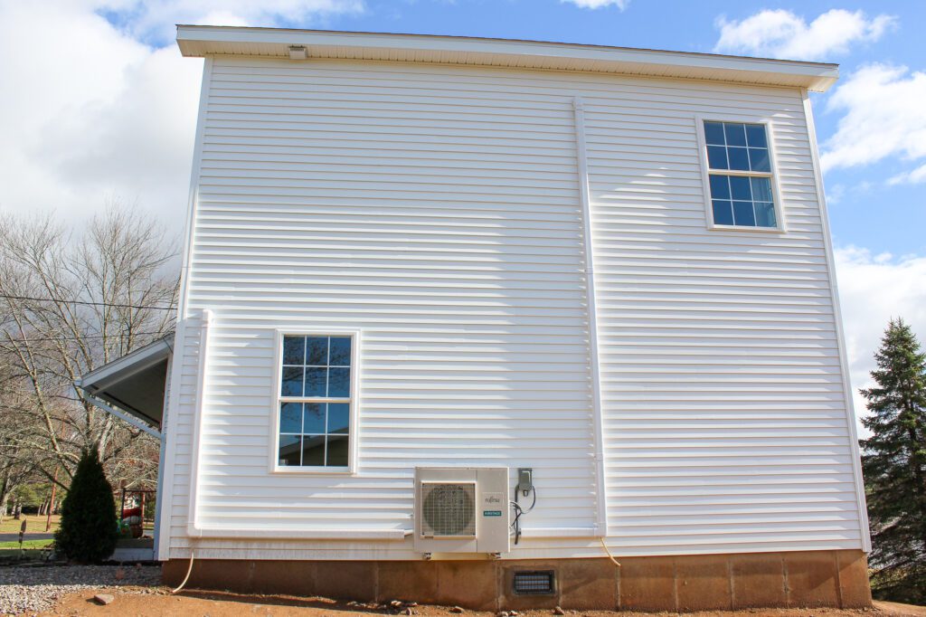 Residential home with newly installed HVAC mini split system as part of energy-efficient HVAC and plumbing maintenance services